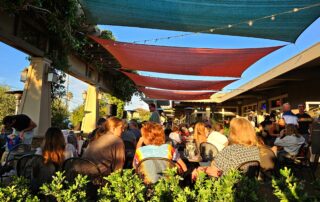 The Patio with many customers sitting, talking, and dining.