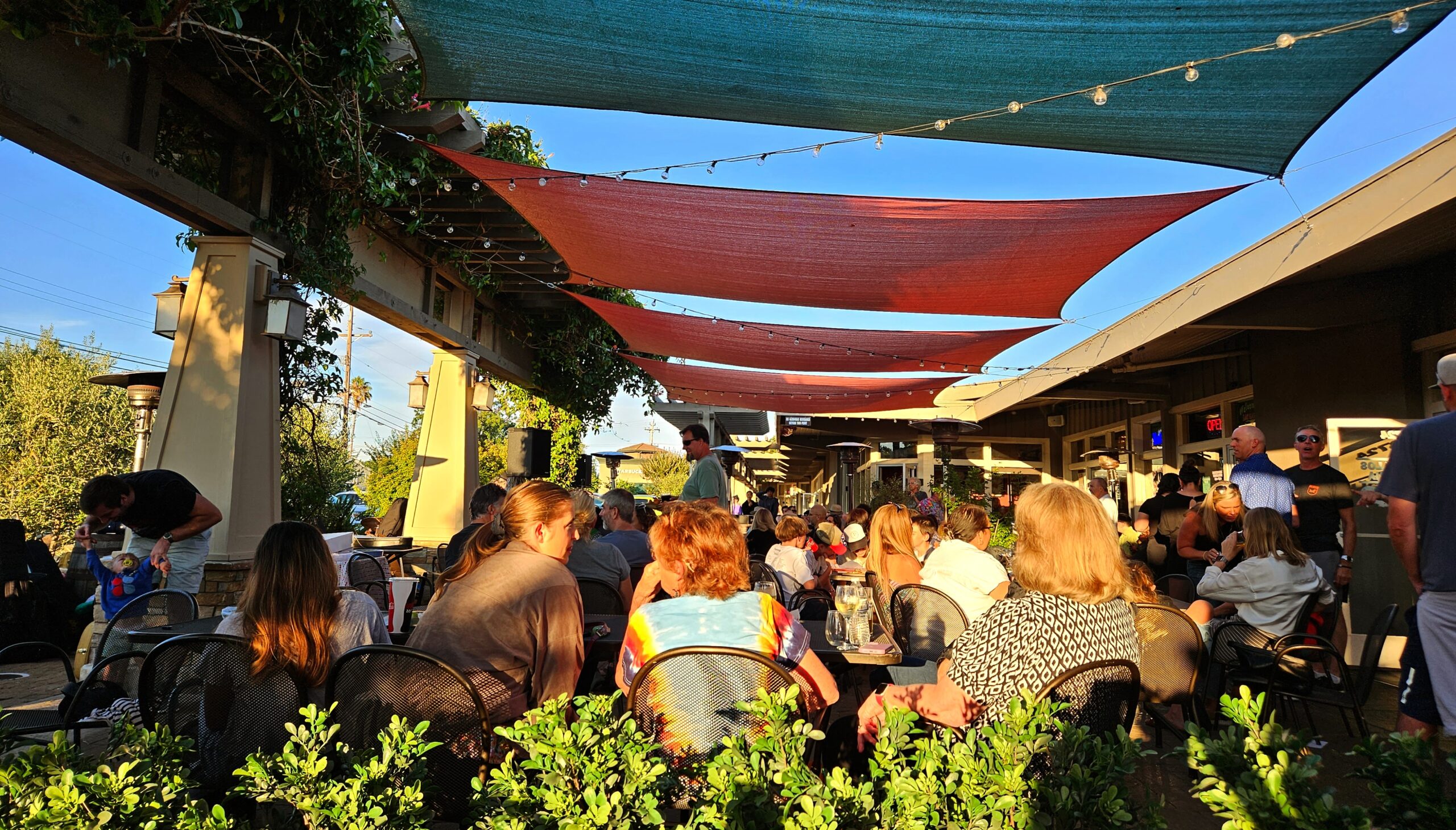 The Patio with many customers sitting, talking, and dining.