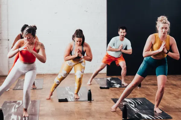 A group of people taking a yoga class at a CorePower studio.