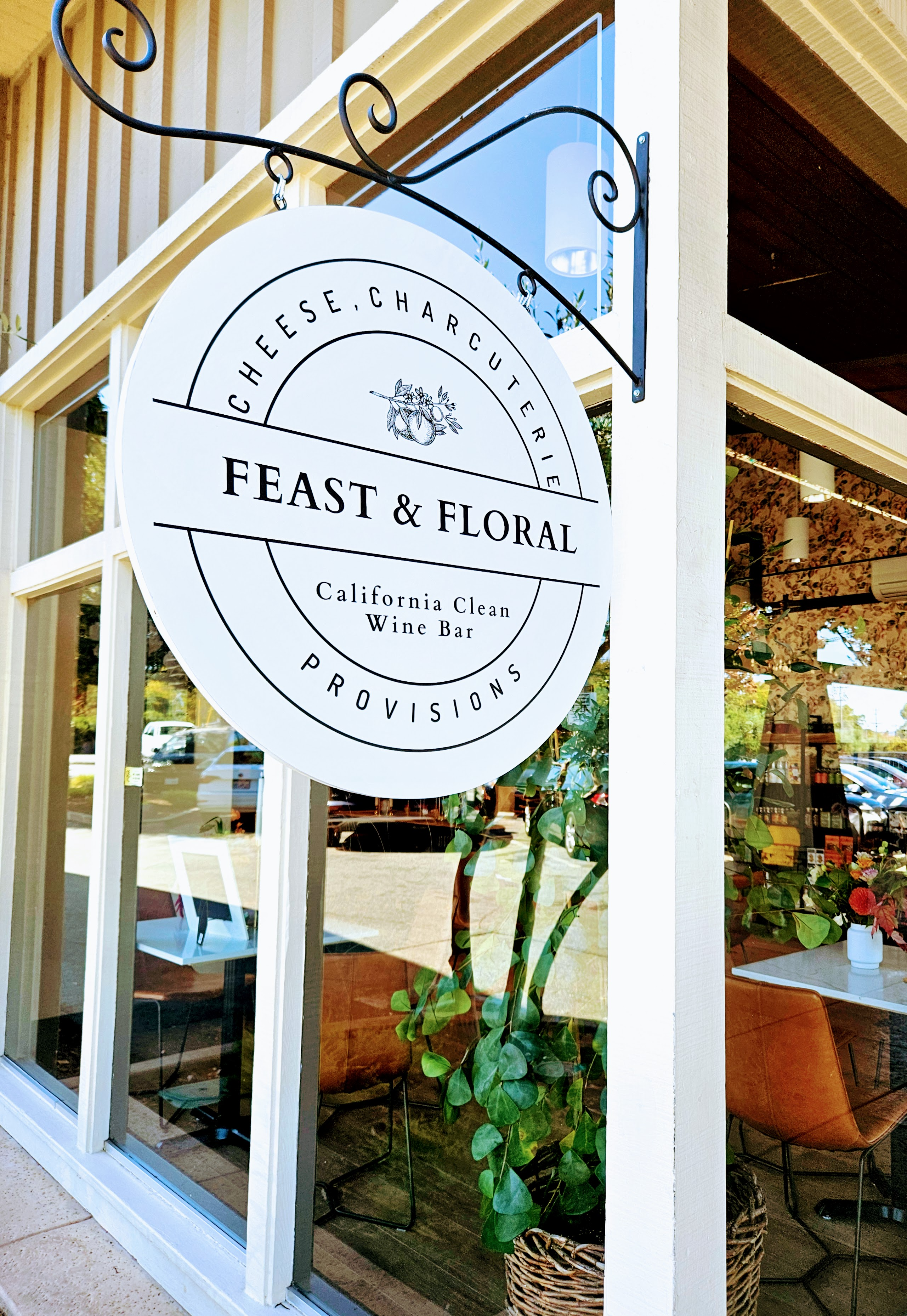 A picture of Feast and Floral's hanging sign outside the shop.