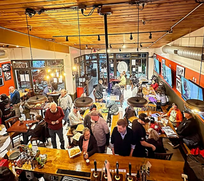 The inside of Freewheel Brewing Company, filled with customers.