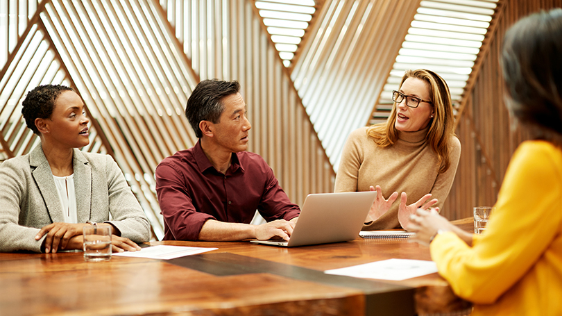 A group of people having a meeting in an office.